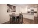 Small dining area with four chairs and a table, near kitchen and living room at 9131 Hitmaker St, Las Vegas, NV 89113