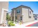 Tan two-story townhome with landscaping and fire hydrant at 9131 Hitmaker St, Las Vegas, NV 89113