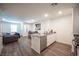 Modern kitchen with island, granite countertops, and stainless steel dishwasher at 9131 Hitmaker St, Las Vegas, NV 89113