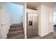 Kitchen area with stainless steel refrigerator and staircase at 9131 Hitmaker St, Las Vegas, NV 89113