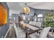 Open concept dining room with modern light fixture and seating for eight at 9131 Sangria Ln, Las Vegas, NV 89147