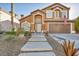 Two story house with a beautiful front yard and attached garage at 9131 Sangria Ln, Las Vegas, NV 89147