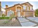 Two-story home with attractive landscaping and a large garage at 9131 Sangria Ln, Las Vegas, NV 89147