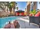 Stunning pool with a gazebo, patio furniture, and palm trees at 9131 Sangria Ln, Las Vegas, NV 89147