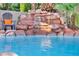 Stunning pool area with a natural rock waterfall feature at 9131 Sangria Ln, Las Vegas, NV 89147