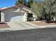 One-story house with attached garage and landscaped front yard at 9489 Santa Fe Rose St, Las Vegas, NV 89123