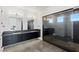 Elegant bathroom with dark vanity, large shower, and modern fixtures at 9525 Ponderay Ct, Las Vegas, NV 89149