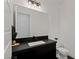 Modern powder room with dark vanity and sleek fixtures at 9525 Ponderay Ct, Las Vegas, NV 89149