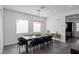 Open dining area with modern chandelier and view into the kitchen at 9525 Ponderay Ct, Las Vegas, NV 89149