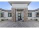 Contemporary front door with stone accents and a paved walkway at 9525 Ponderay Ct, Las Vegas, NV 89149