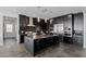 Modern kitchen with dark cabinetry, stainless steel appliances and island at 9525 Ponderay Ct, Las Vegas, NV 89149