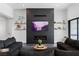 Living room with a black fireplace, TV, and floating shelves at 9525 Ponderay Ct, Las Vegas, NV 89149