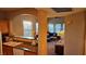 Kitchen with wood cabinets, granite countertops, and a view of the living room at 9975 Peace Way # 2089, Las Vegas, NV 89147