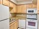 Galley kitchen with wood cabinets and appliances at 100 S Crestline Dr # 57, Las Vegas, NV 89107