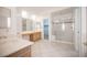 Elegant bathroom with double sinks, a shower, and tile flooring at 10009 Dusty Winds Ave, Las Vegas, NV 89117