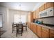 Bright kitchen with wood cabinets, granite countertops, and a breakfast nook at 10009 Dusty Winds Ave, Las Vegas, NV 89117