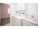 Bright laundry room with washer, dryer, and utility sink at 10009 Dusty Winds Ave, Las Vegas, NV 89117