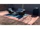 Relaxing patio with seating area, grill, and gravel landscaping at 1036 Novara Ln, Las Vegas, NV 89144