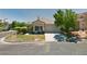 Single story home with attached garage and landscaped yard at 1036 Novara Ln, Las Vegas, NV 89144