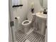 Clean bathroom with pedestal sink and striped rug at 10411 Rose Palisade St, Las Vegas, NV 89141