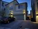 Two-story house with a two car garage at dusk at 10411 Rose Palisade St, Las Vegas, NV 89141