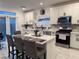 Modern kitchen with white cabinets and center island at 10411 Rose Palisade St, Las Vegas, NV 89141