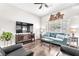 Bright living room with wood floors, contemporary furniture, and a large window at 10725 Sky Meadows Ave, Las Vegas, NV 89134