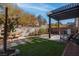 Relaxing backyard with pergola, grass, and seating area at 1112 Via Monticano, Henderson, NV 89052