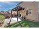 Covered patio, grassy area, and brick pavers create a relaxing backyard space at 1112 Via Monticano, Henderson, NV 89052