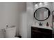 Small bathroom with dark vanity and oval mirror at 1112 Via Monticano, Henderson, NV 89052