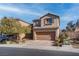 Two-story house with brown exterior, attached garage, and landscaped front yard at 1112 Via Monticano, Henderson, NV 89052