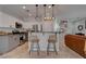 Modern kitchen with gray and white cabinets, stainless steel appliances, and island with seating at 1112 Via Monticano, Henderson, NV 89052