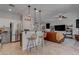 Modern kitchen with gray and white cabinets, stainless steel appliances, and island with seating at 1112 Via Monticano, Henderson, NV 89052