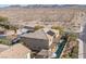 Two-story house with solar panels, pool, and backyard, aerial view at 1137 Glistening Point Ave, Henderson, NV 89015