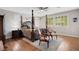 Main bedroom with a large four poster bed and sitting area at 1137 Glistening Point Ave, Henderson, NV 89015
