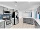 Modern kitchen with gray cabinets, quartz countertops, and stainless steel appliances at 1411 Norman Ave, Las Vegas, NV 89104