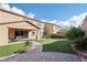 Landscaped backyard with artificial turf, paver patio, and fire pit at 1557 Mistywood Ct, Henderson, NV 89014