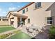 Backyard patio with table and chairs, surrounded by artificial grass at 1557 Mistywood Ct, Henderson, NV 89014