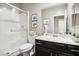 Clean bathroom with a walk-in shower, toilet and a vanity with dark brown cabinets at 1557 Mistywood Ct, Henderson, NV 89014