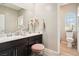 Elegant bathroom with double vanity, a separate toilet area, and pink accents at 1557 Mistywood Ct, Henderson, NV 89014