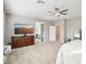 Bright bedroom with ensuite bathroom access and large TV at 1557 Mistywood Ct, Henderson, NV 89014