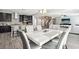 Spacious dining area with marble table and view of kitchen and staircase at 1557 Mistywood Ct, Henderson, NV 89014