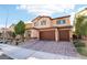 Two-story house with a three-car garage and brick driveway at 1557 Mistywood Ct, Henderson, NV 89014