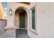 Inviting front entrance with arched doorway and stone accents at 1557 Mistywood Ct, Henderson, NV 89014