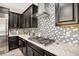 Modern kitchen with stainless steel appliances and granite countertops at 1557 Mistywood Ct, Henderson, NV 89014