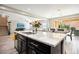 Large kitchen island with granite countertop and stainless steel sink at 1557 Mistywood Ct, Henderson, NV 89014