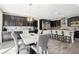 Modern kitchen with island, stainless steel appliances, and dark cabinets at 1557 Mistywood Ct, Henderson, NV 89014