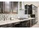 Modern kitchen with gas cooktop, custom cabinetry, and hexagon backsplash at 1557 Mistywood Ct, Henderson, NV 89014