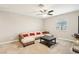 Spacious living room with neutral carpeting and a ceiling fan at 1557 Mistywood Ct, Henderson, NV 89014