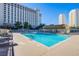 Refreshing community pool with surrounding lounge chairs at 205 E Harmon Ave # 1012, Las Vegas, NV 89169